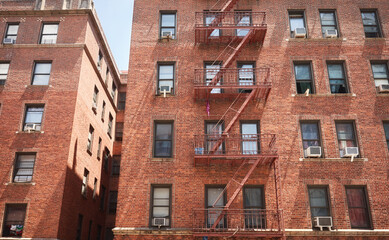 Obraz premium Old red brick building with fire escape, New York City, USA.