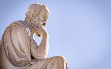 Socrates the ancient Greek philosopher and thinker white marble statue under blue sky, space for...