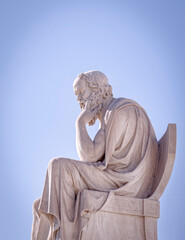 Socrates the ancient Greek philosopher and thinker white marble statue under blue sky, Athens Greece
