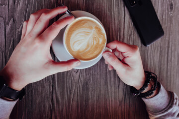 top view of a man's hand drinking coffee