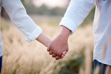 Close-up of a business handshake between two white shirts at every grass.
