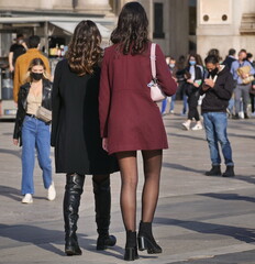 Female couple walking in Duomo square, Milan, Italy