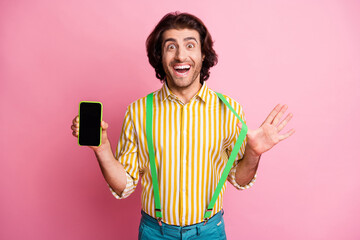 Photo of young attractive man happy positive smile hold cellphone promotion advert offer isolated...