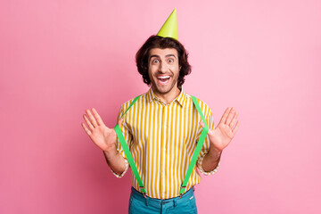 Photo of young attractive man happy positive smile excited wear party hat isolated over pink color...