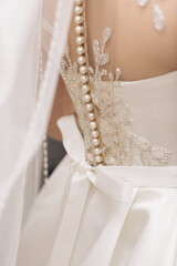 Luxurious wedding dress nearby. Best Wedding Morning. Wedding concept. Beautiful Lace Bridal Wedding Dress with Back