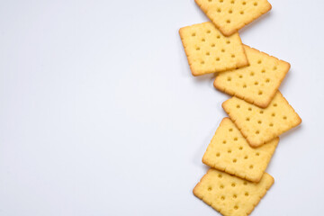 line of crackers put on white table with empty space