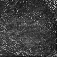 Crumpled dark plastic packing texture background