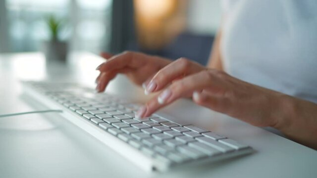 Accelerated video of female hands typing on a computer keyboard. Concept of remote work. Quick motion. Timelapse