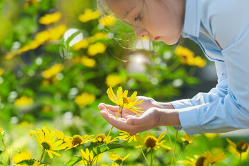 Yellow flower in the hands of child. World Environment Day. Earth day.