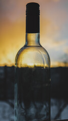 an empty wine bottle at sunset photo