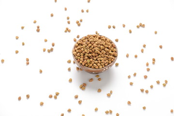 Dried chickpeas in bowl isolated on white background.