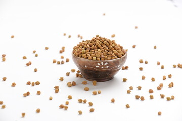Dried chickpeas in bowl isolated on white background.