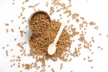 Dried chickpeas in bowl isolated on white background.