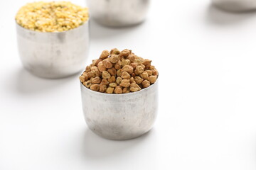 Dried chickpeas in bowl isolated on white background.