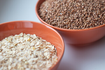 oatmeal and buckwheat in two different plates