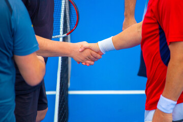 tennis players congratulate each other after the end of a tennis match