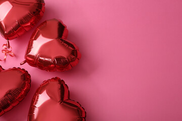 Red heart shaped balloons on pink background, flat lay with space for text. Saint Valentine's day...