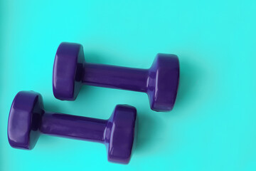 Purple dumbbells on blue background
