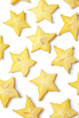 Slices of delicious carambola on white background, top view