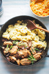 Teriyaki pork loins in whiskey, coffee and rosemary sauce, served with couscous and salad