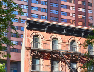 Fototapeta na wymiar Old building with iron fire escape in Manhattan, New York City, USA.