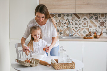 family, food and people concept - happy mother and daughter having breakfast at home