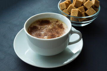Cup of coffee and sugar on table closeup