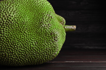 Fresh exotic jackfruit on black wooden table, closeup