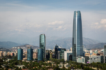 Skyline of modern buildings at financial district with The Andes mountain range in the back.