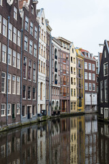 Fototapeta na wymiar Amsterdam canal houses and their reflections in the water