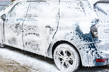 High pressure automobile cleaning with foam in car wash.