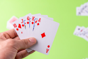Cards from ten to ace. Poker. Green background. Froma above. Place for text