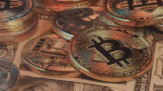 Close-up, Smoke reveals dollar bills and stack of bitcoin coins. Crypto currency