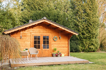 Wooden garden shed with terrace. Wooden garden shed. Life in the country in Germany in summer....