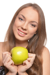 Portrait of beautiful young woman with green apple