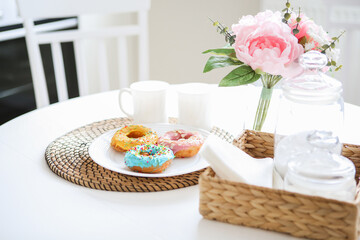 breakfast bright donuts with milk in a light kitchen on a white plate. food concept.
delicious lunch