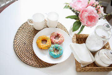 breakfast bright donuts with milk in a light kitchen on a white plate. food concept.
delicious lunch