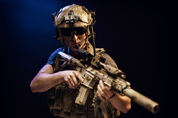 Special forces soldier with rifle on black background