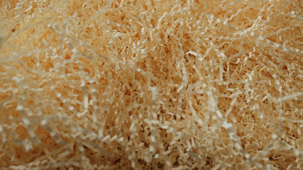 Shredded paper texture, filling for gift box, stuffing and shipping. Brown decorative straws fillers for your product placement. Centre composition with empty space for produce. Paper trash texture.