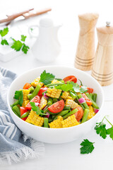 Vegetable green beans and corn salad with tomato, red onion and parsley
