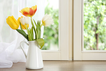 Beautiful fresh tulips on window sill indoors. Spring flowers