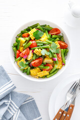 Vegetable green beans and corn salad with tomato, red onion and parsley