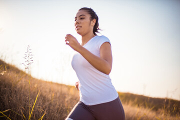 Female runner jogging in nature.