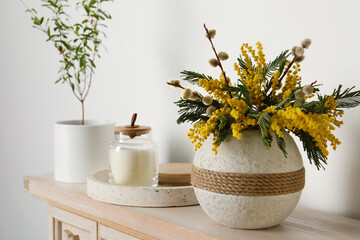 Beautiful mimosa flowers in vase on wooden table