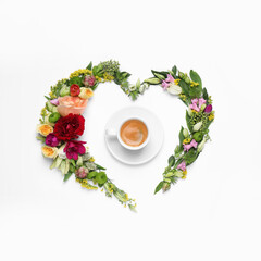 Obraz na płótnie Canvas Beautiful heart shaped floral composition with cup of coffee on light background, flat lay