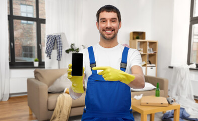 male worker or cleaner showing smartphone at home
