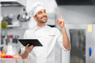 male chef with tablet computer pointing finger up