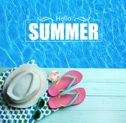 Fototapeta na wymiar Hello Summer. Beach accessories on light blue wooden deck near swimming pool, flat lay