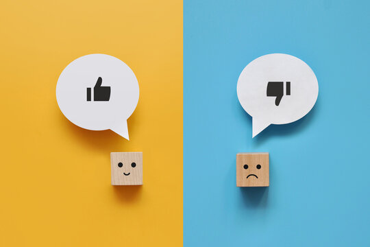 Wooden cubes with the image of like and dislike. Choose between like and dislike