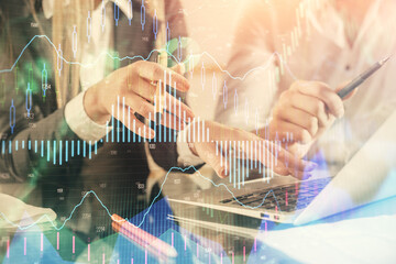 Multi exposure of man and woman working together and financial chart hologram. Business concept. Computer background.